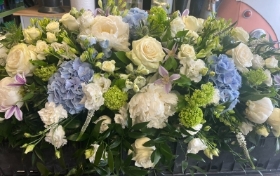 White Rose and blue hydrangea casket spray