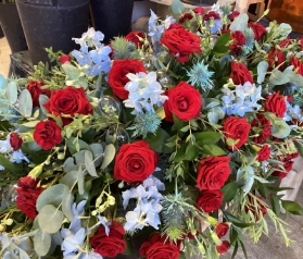 Red Rose, Blue Delphinium and Thistle Casket Spray