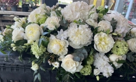 White hydrangea and peony casket spray